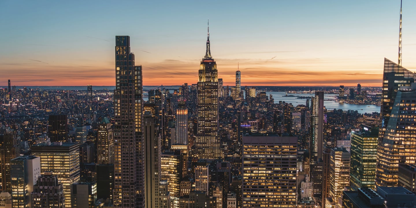 Manhattan skyline at dusk, with the Empire State Building at the center.